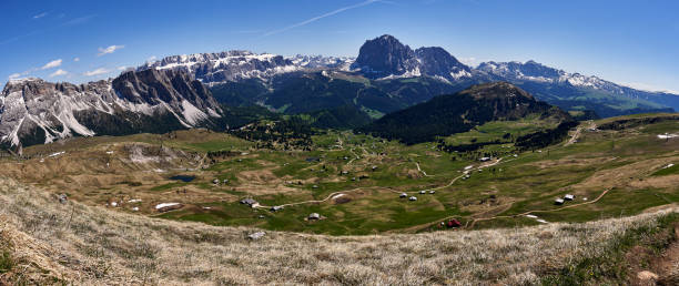 panoramic view of the upper area of ​​seceda with a green meadow and mountains in the background in the italian dolomites, europe stock photo