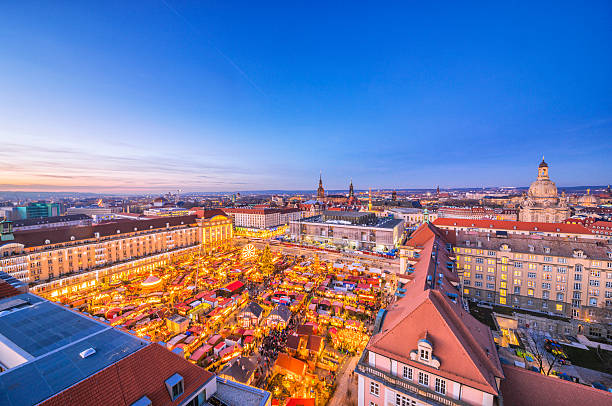 Panoramic view over Dresden and the Striezelmarkt at dusk Panoramic view over the skyline of Dresden and the world-famous christmas market (Striezelmarkt) at dusk. dresden germany stock pictures, royalty-free photos & images