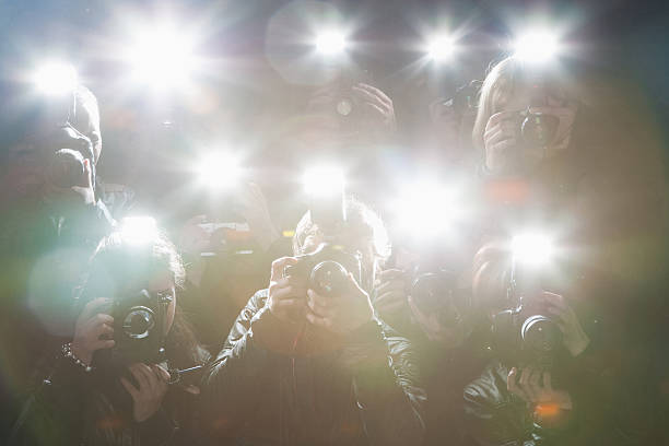 Paparazzi taking pictures with flash  fame stock pictures, royalty-free photos & images
