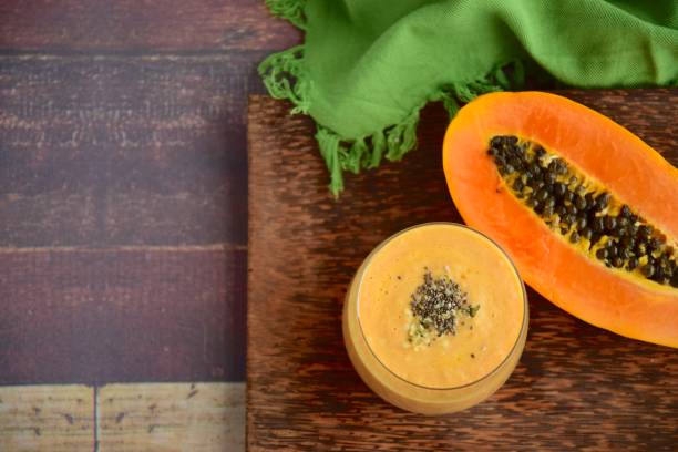 Papaya banana mango smoothie with chia seeds and hemp seeds Papaya banana mango smoothie with chia seeds and hemp seeds. Flat lay papaya smoothie stock pictures, royalty-free photos & images