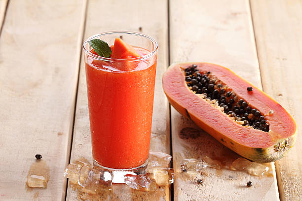 papaya smoothie healthy fruity smoothie with papaya in a glass papaya smoothie stock pictures, royalty-free photos & images