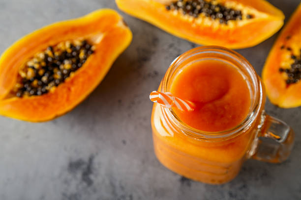 Papaya smoothie, selective focus. Detox, diet food. Papaya smoothie, selective focus. Detox, diet food, vegetarian food, healthy eating concept. papaya smoothie stock pictures, royalty-free photos & images