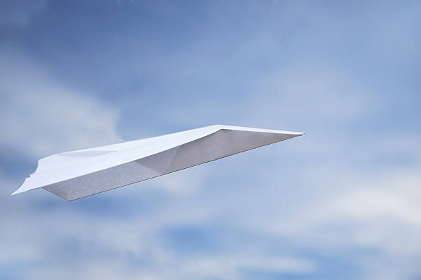 Paper Airplane In Flight stock photo
