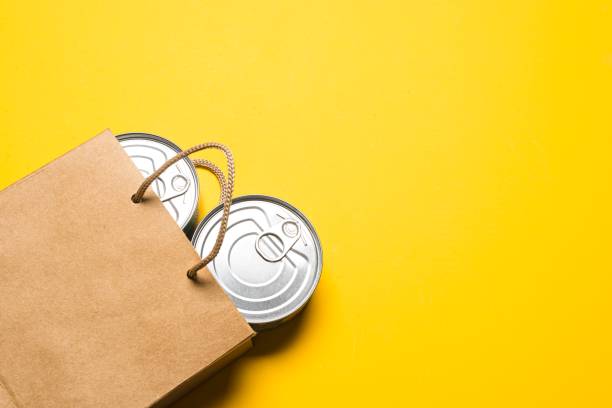 Paper bag with canned food stock photo