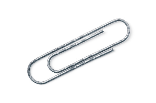 Old steel paper clip isolated on white