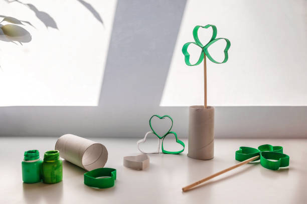 DIY paper clover with toilet roll tube for Saint Patrick Day celebration, zero waste decor for party stock photo