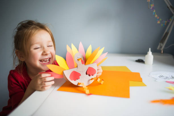 paper craft for kids. DIY Turkey made for thanksgiving day. create art for children. girl playing with a toy paper craft for kids. DIY Turkey made for thanksgiving day. create art for children. girl playing with a toy. craft stock pictures, royalty-free photos & images