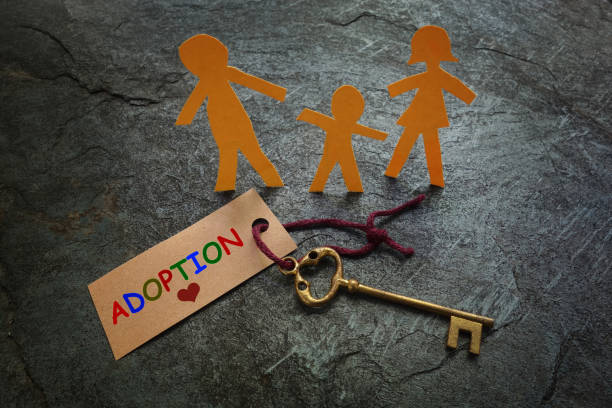 Paper family gold Adoption key  adoption stock pictures, royalty-free photos & images