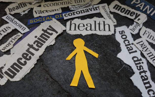 Paper man surrounded by Corona Virus and economic news headlines Paper man cutout surrounded by Corona Virus and economic news headlines mental health stock pictures, royalty-free photos & images
