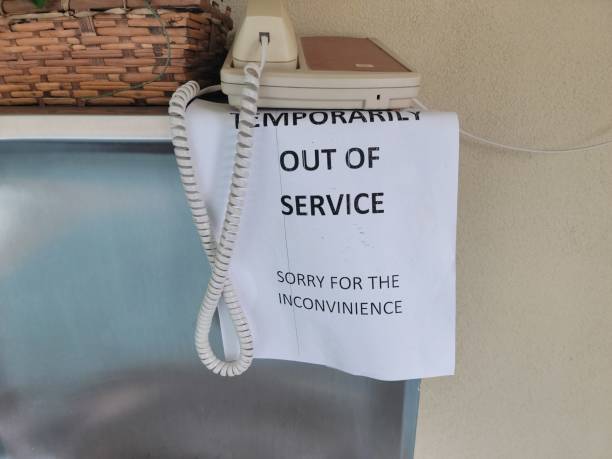 paper out of service sign on telephone stock photo