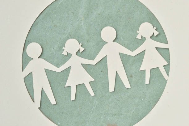 Paper silhouette of children - Ecology and social responsibility concept Paper silhouette cut of children chain - Ecology and social responsibility concept social responsibility stock pictures, royalty-free photos & images