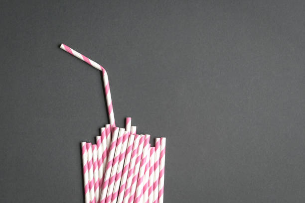 Paper straws in the shape of drinking glass stock photo
