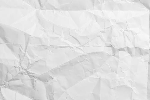 Paper crumpled texture. White wrinkled paper sheet.