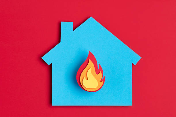 papercut house with fire inside. home insurance, security, safety, damage, accident prevention - fire imagens e fotografias de stock