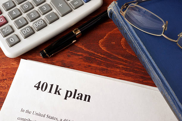 Papers with 401k plan and book on a table. Papers with 401k plan and book on a table. 401k stock pictures, royalty-free photos & images
