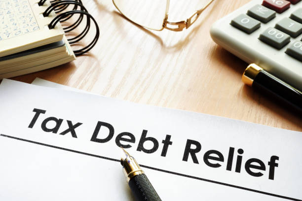 Papers with title tax debt relief on a desk. Papers with title tax debt relief on a desk. relief carving stock pictures, royalty-free photos & images