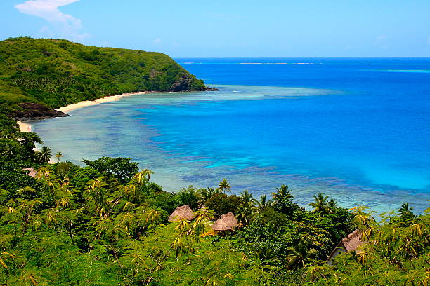 Paradise: above Fiji Yasawa islands, deserted turquoise beach and palapas stock photo
