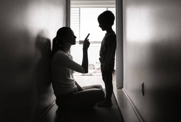 Parent disciplining and talking to the boy stock photo
