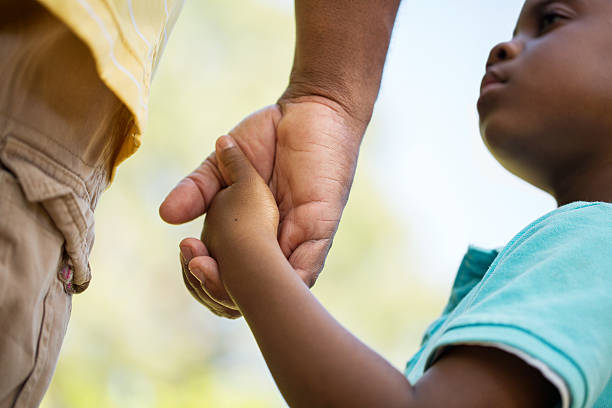 Parenting African American father and son holding hands stock pictures, royalty-free photos & images