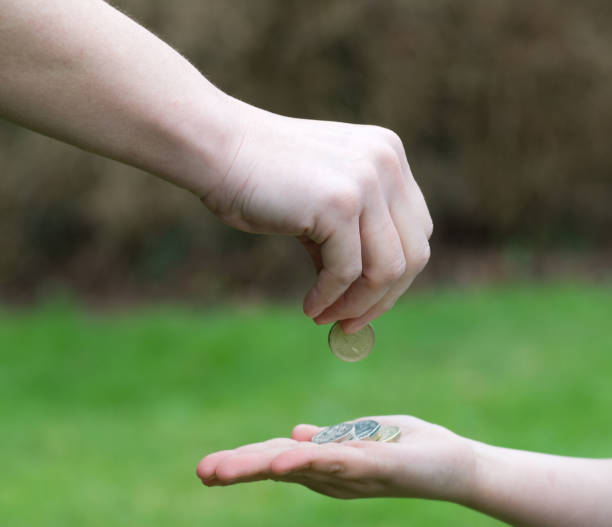 Parents hand giving Pocket money to child stock photo