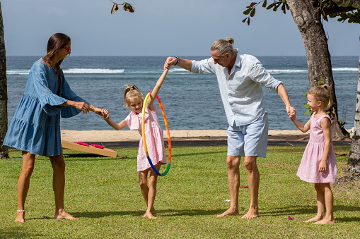 parents-playing-exciting-hula-hoop-pass-game-with-children-by-the-sea-picture-id1271287030?b=1&k=20&m=1271287030&s=170667a&w=0&h=8bWvEvir4n2y4gWzOFj02-eZYLCztrCO-S6qzzmk_O0=