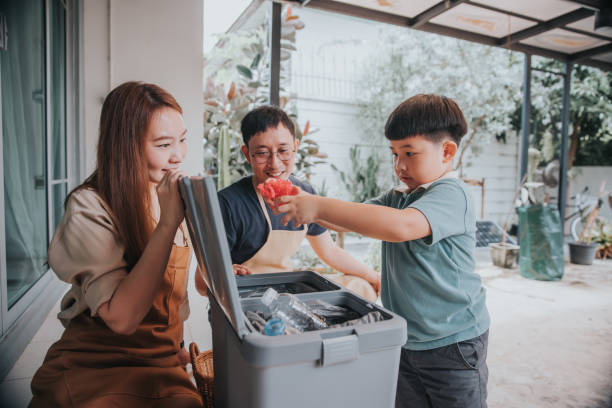 Parents teaching their son how to separate waste-stock photo stock photo