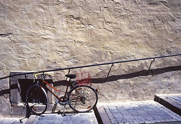 Parked Bicycle Along Textured Wall stock photo
