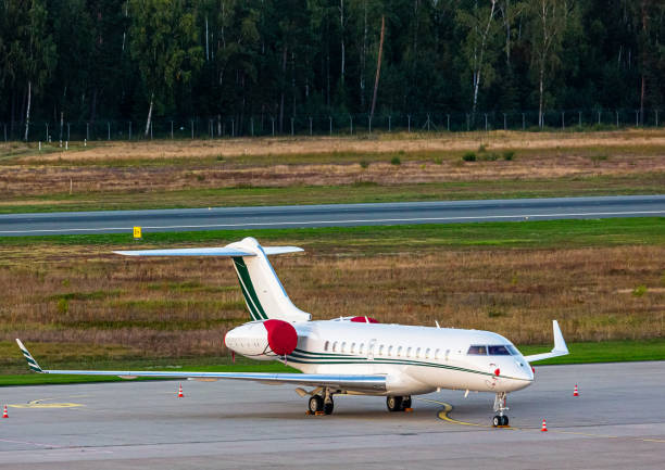 Parked business Jet with engines covered up stock photo