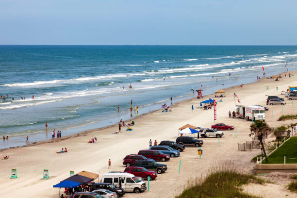 Parking right on the beach by the ocean is really convenient and fun at the Daytona and New Smyrna Beach in Florida stock photo