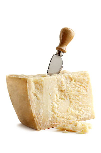 parmesan cheese with knife stock photo