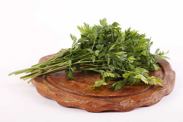 Parsley on a wooden plate stock photo