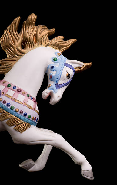 Part of a colorful carousel horse over a black background Colorful carousel horse isolated on black background carousel horses stock pictures, royalty-free photos & images