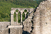 Tintern Abbey was founded by Walter de Clare in 1131. Situated on the River Wye in Monmouthshire, it was only the second Cistercian foundation in Britain, and the first in Wales. It is one of the most spectacular ruins in the country and inspired the William Wordsworth poem "Tintern Abbey",and more than one painting by J. M. W. Turner