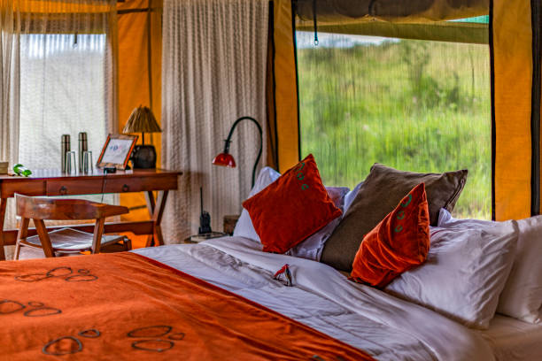 Partial view of bedroom in exclusive, luxury safari tented camp, in the Serengeti NP, Tanzania. stock photo
