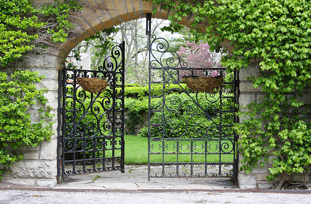A partially open gate leading into a garden A partially open gate, entrance to a garden gate stock pictures, royalty-free photos & images