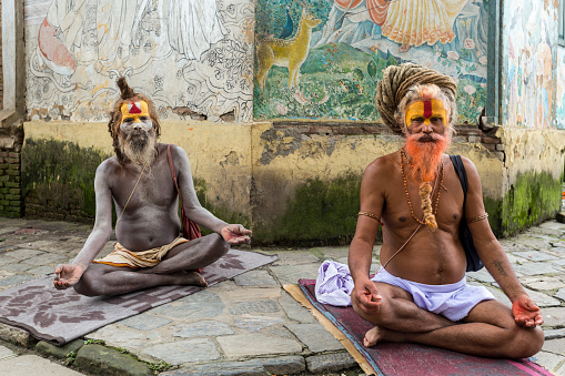 Two Sadhus meditating in the Pashupatinath Temple, the most famous and sacred Hindu temple complex, a UNESCO World Heritage Site located on the banks of the sacred Bagmati River, Kathmandu Valley, Nepal. Photo taken on 31 July 2018.