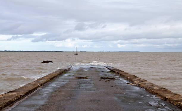 Passage of gois in Vendée Passage du Gois cut off from Noirmoutier island because of the high tide. dead end road stock pictures, royalty-free photos & images