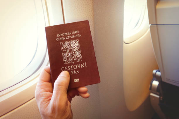 Passenger holding Czech passport on the airplane stock photo
