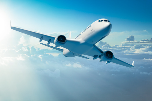 Passenger Jet Airplane Over Clouds Stock Photo Download Image