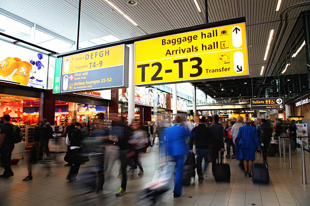 passengers are walking in amsterdam airport schiphol, netherland - schiphol stockfoto's en -beelden
