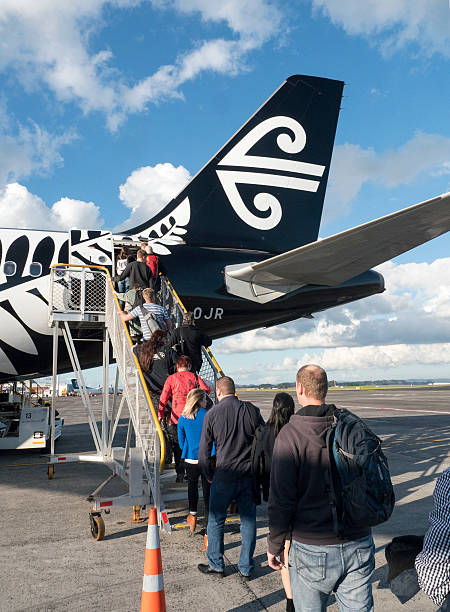 Passengers boarding Air New Zealand flight stock photo