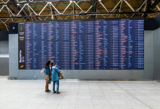 Moscow, Russia - June 26. 2019. Passengers look at the departure board in Sheremetyevo International Airport, new terminal B stock photo