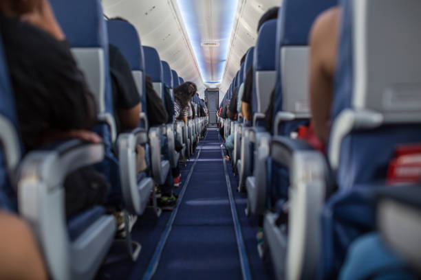 Passengers traveling by a plane, shot from the inside of an airplane stock photo