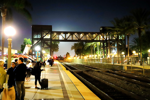 Fullerton, CA, USA - Oct.13.2019: Passengers waiting for train at Fullerton Station.

Fullerton Station located at Fullerton, CA. This station serves by Amtrak and Metrolink train services.

Passengers are waiting for the trains on the platform.