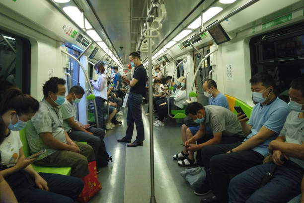 Passengers with face masks travel in subway during coronavirus pandemic in Beijing. stock photo
