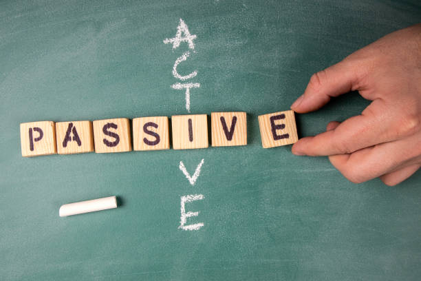 Passive and Active. Text from letters of the wooden alphabet Passive and Active. Text from letters of the wooden alphabet on a green chalk board serene people stock pictures, royalty-free photos & images