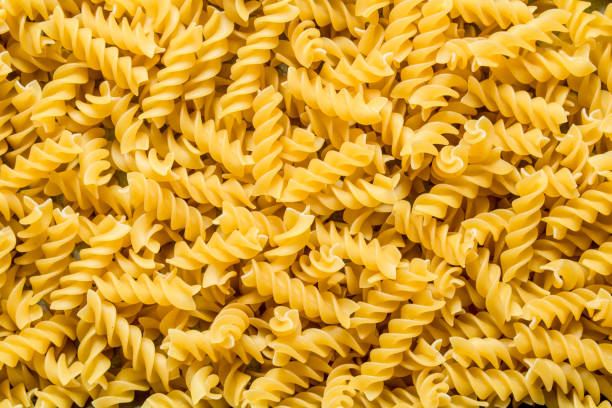 Pasta background. Dry pasta fusilli. stock photo