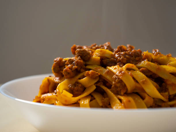 Pasta bolognese. Tagliatelle with bolognese sauce. Fettuccine with meat sauce. Tomato sauce and minced meat. Pasta with ragù, typical Italian food. stock photo