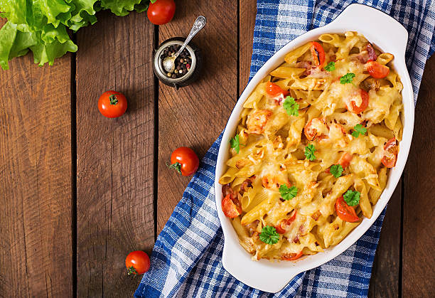 Pasta casserole, tomato, bacon and cheese. Top view Pasta casserole, tomato, bacon and cheese. Top view gratin stock pictures, royalty-free photos & images