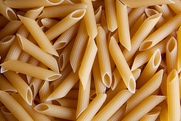 Pasta penne rigate  uncooked pasta stock pictures, royalty-free photos & images